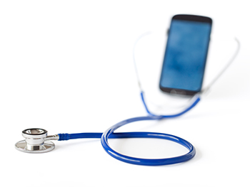 Stethoscope and mobile phone isolated on white background